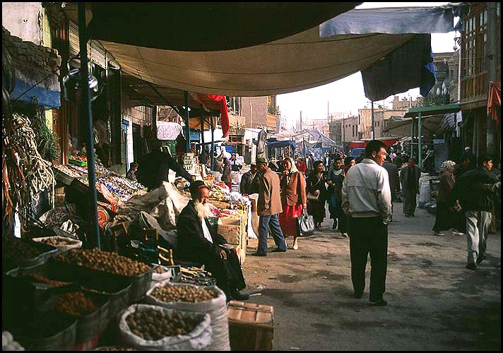 Produce spilling into the streets<br><br>Kashgar :: Xinjiang, China: Kashgar, Xinjiang, People's Republic of China
: City Scenes; Food Stalls and Markets.
