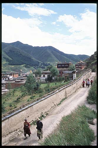 Tibetan Pilgrims circumnavigating Labrang Si: Xiahe -- Labrang Si, Gansu, People's Republic of China
: People You Meet; Temples.