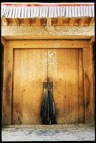 Doorway and prayer shawls.: Xiahe -- Labrang Si, Gansu, People's Republic of China
: Buildings; Temples.