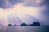 A picture of the sun streaming through clous On the Andaman Sea; near Krabi, Thailand